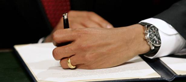 U.S. President Barack Obama signs his first act as president in Washington