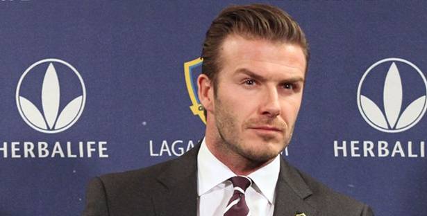 LOS ANGELES, CA - JANUARY 19: Midfielder David Beckham gets ready in his seat for the press conference announcing his new contract with the Los Angeles Galaxy at Staples Center on January 19, 2012 in Los Angeles, California.   Victor Decolongon/Getty Images/AFP