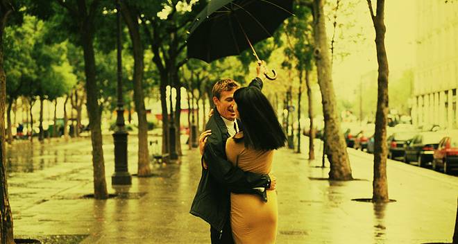 Couple Walking Under Umbrella