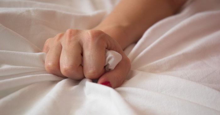 Woman s Hand Squeezing Bed Sheet
