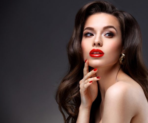 Beauty Model Woman with Long Brown Wavy Hair.  Red Lips