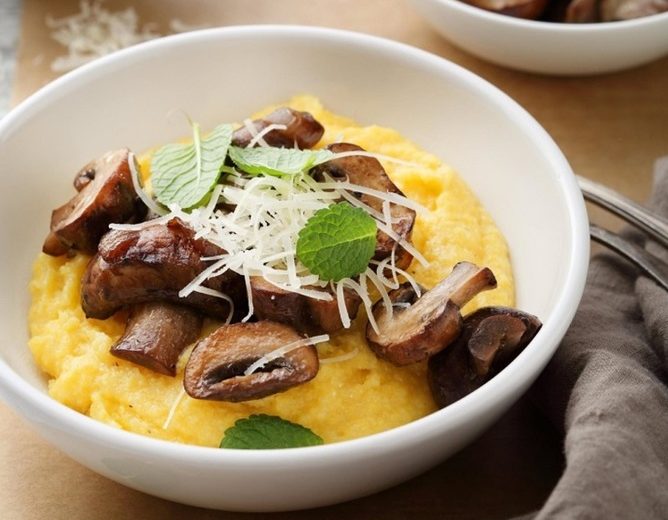 soft italian polenta in white bowl, food close-up