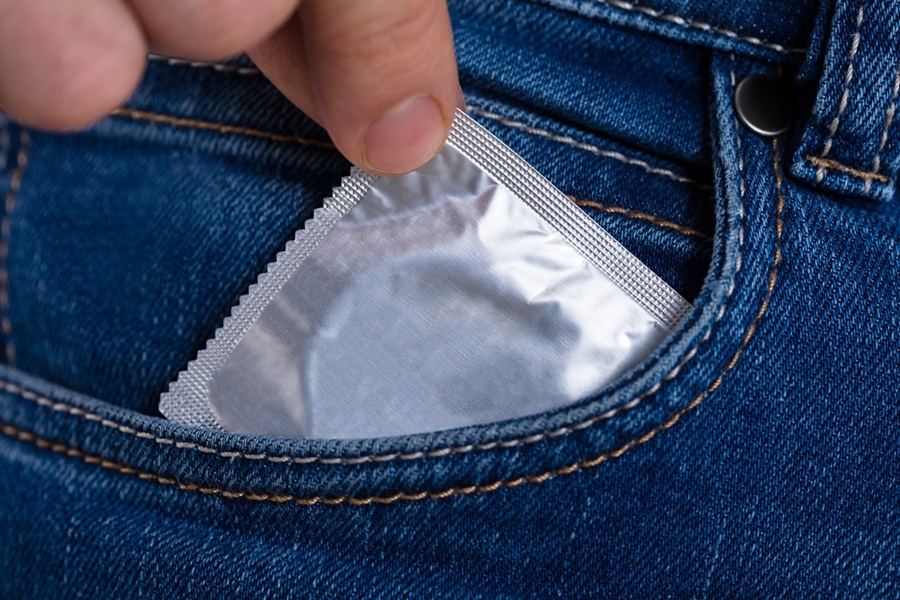 Silver Color Condom In The Pocket Of A Blue Jeans