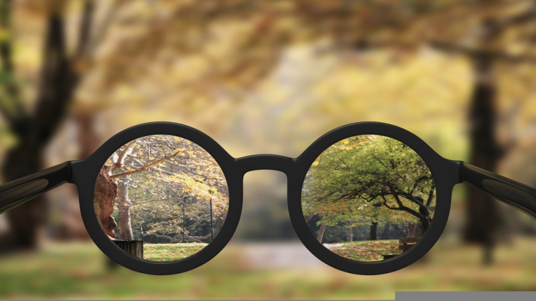 Closeup,On,Eyeglasses,With,Focused,And,Blurred,Landscape,View.