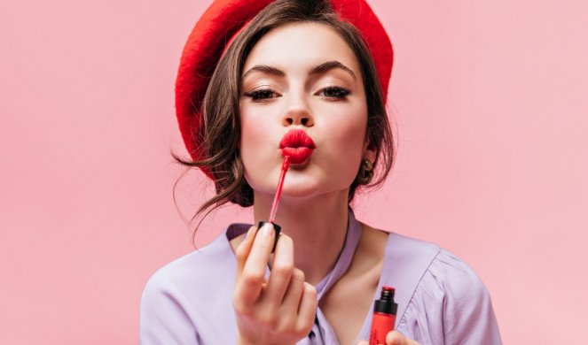 534651_portrait-young-girl-red-beret-painting-her-lips-with-bright-lipstick-pink-background_f