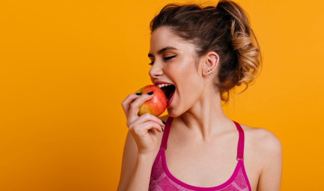 620059_indoor-photo-blissful-woman-eating-apple_f