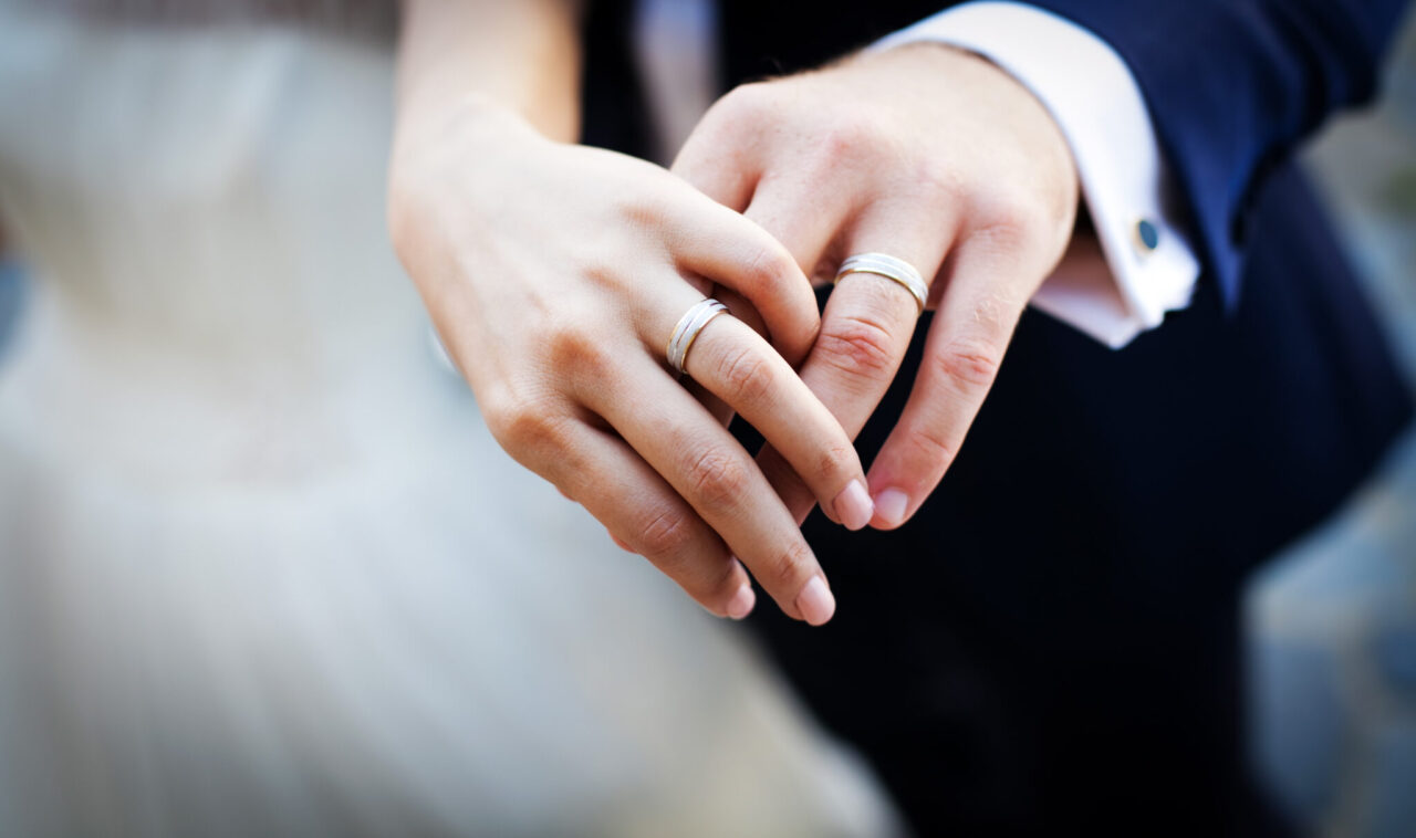 Newly,Wed,Couple's,Hands,With,Wedding,Rings