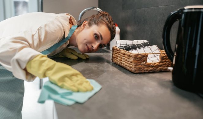 677525_young-dark-haired-woman-cleaning-surfaces-kitchen_f