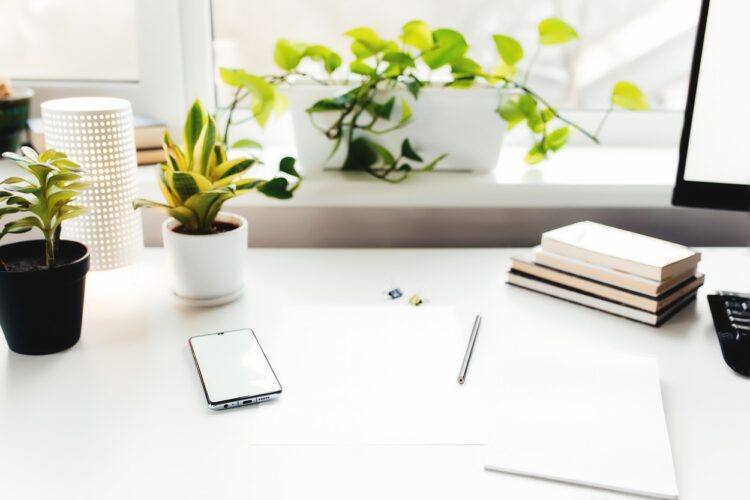 Smartphone on white table, work from home, office stuff