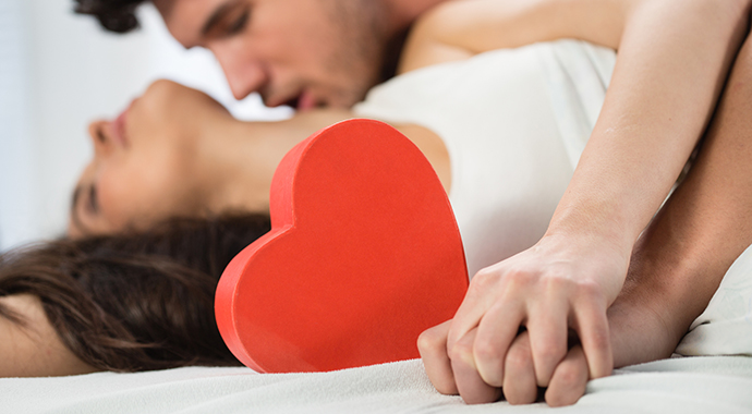 Young couple kissing in bed