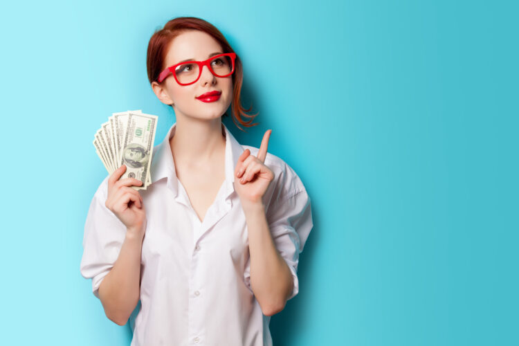 Portrait,Of,Redhead,Women,In,Red,Glasses,With,Money,On