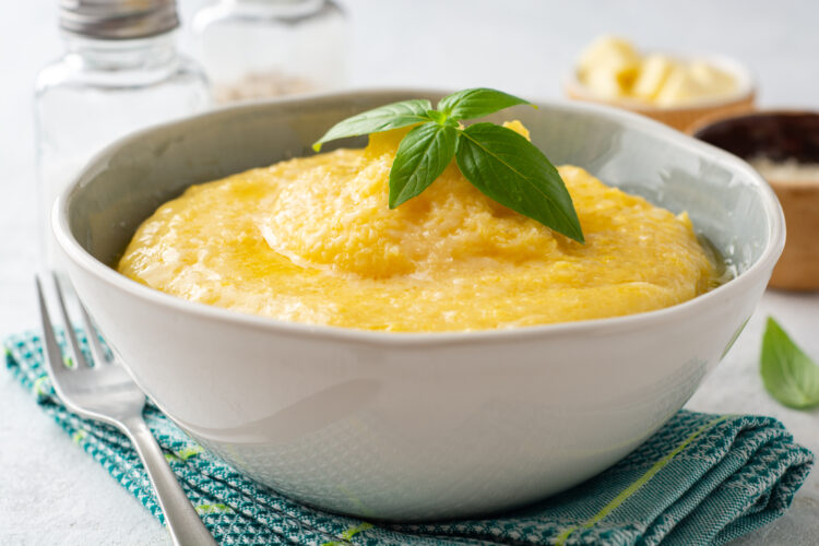 Polenta,With,Butter,And,Parmesan,Cheese,In,Bowl,On,Concrete