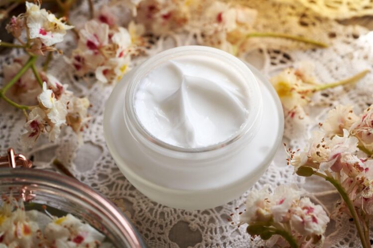 White horse chestnut cream in a glass jar with fresh Aesculus hippocastanum flowers collected in spring