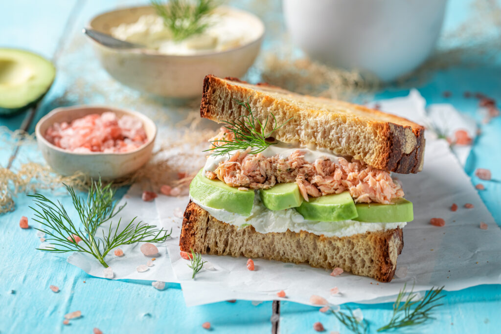 Tasty sandwich with avocado, salmon and dill for healthy breakfa