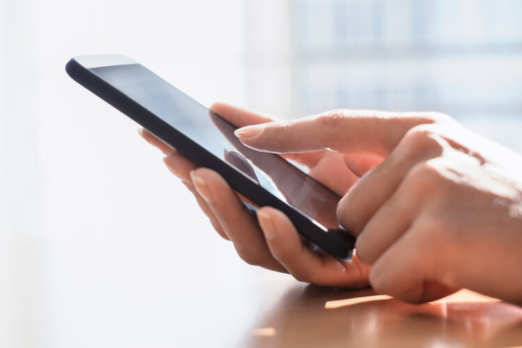 Close,Up,Of,Hands,Woman,Using,Her,Cell,Phone.,Indoor