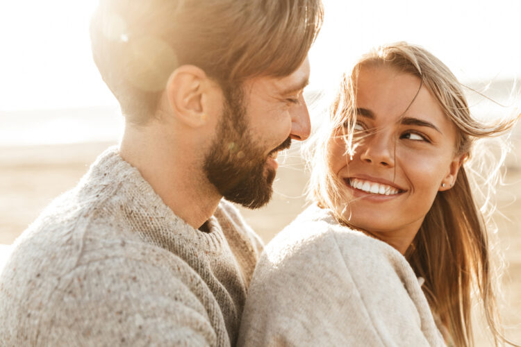 Close,Up,Of,A,Smiling,Beautiful,Young,Couple,Embracing,While