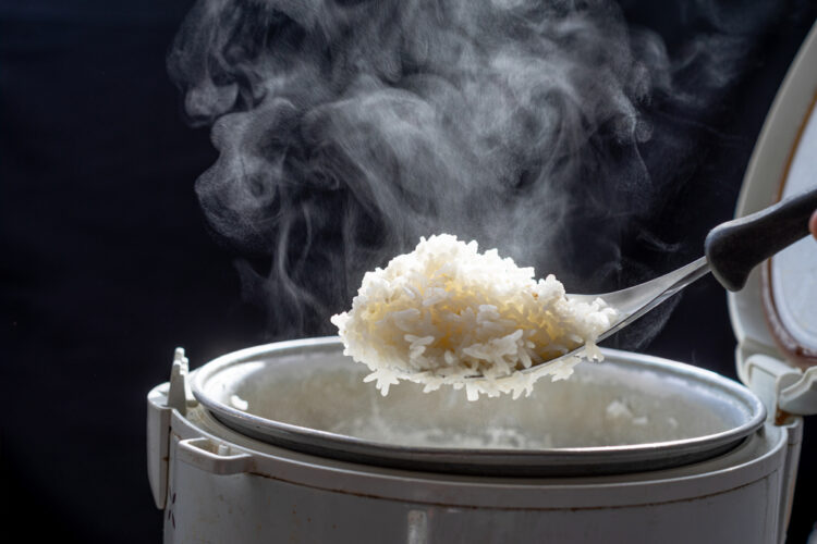 Jasmine,Rice,Cooking,In,Electric,Rice,Cooker,With,Steam,On