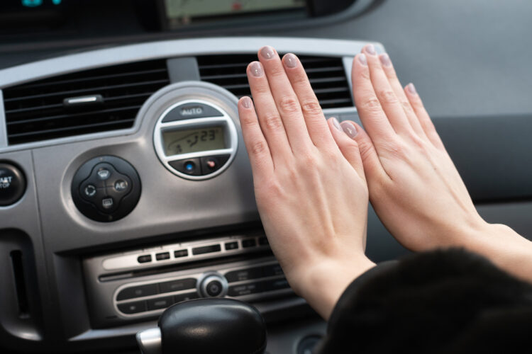 The,Girl,Holds,Her,Hands,Over,The,Car's,Hot,Air