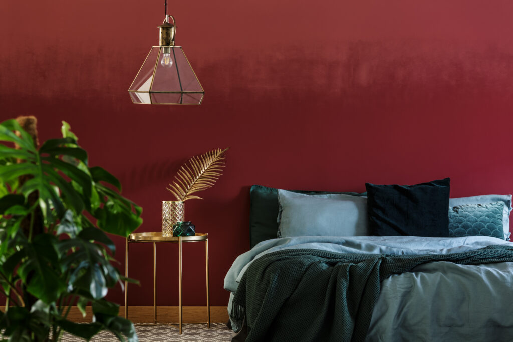 Lamp,Above,Gold,Table,Next,To,Emerald,Green,Bed,In